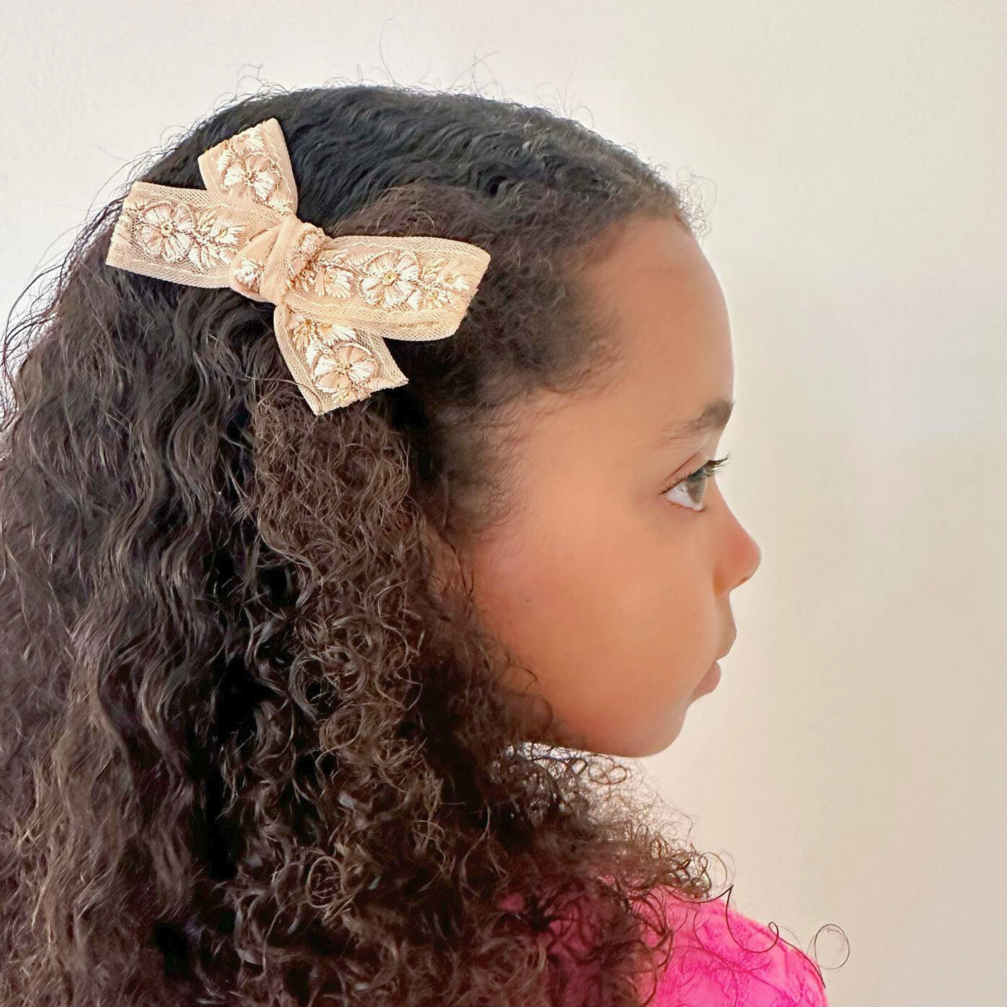 Charlotte Embellished Hair Bow in blush with delicate matching floral embellishments and golden accents, suitable for newborns to adults with versatile wearing options including headband and clips.