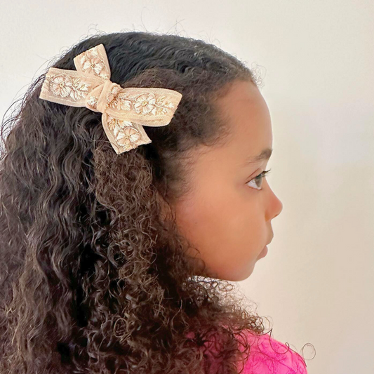 Charlotte Embellished Hair Bow in blush with delicate matching floral embellishments and golden accents, suitable for newborns to adults with versatile wearing options including headband and clips.