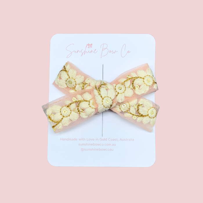 Hair Bow, a pink, shimmering accessory for babies and girls.