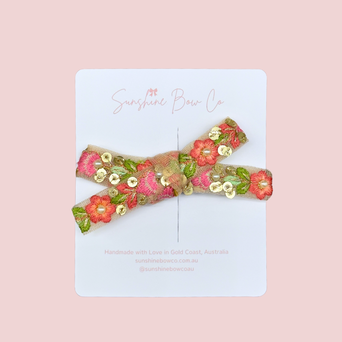 Pearl Pink Hair Bow, an embellished pink bow with pearls for babies and girls, featuring a soft headband for infants and secure clips for older girls.