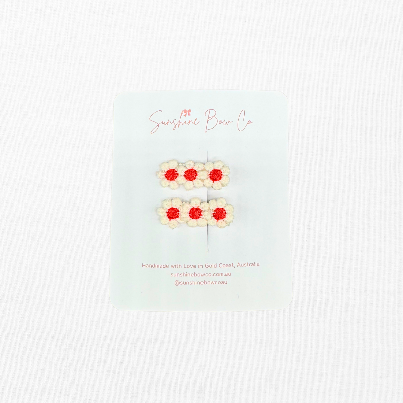 two hair red daisy hair clips for toddlers.