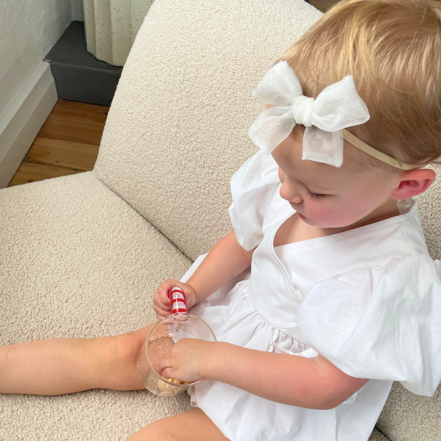 Girl wearing the Diamond Hair Bow, a shimmering accessory from the Christmas collection. This elegant bow, reminiscent of a sparkling diamond, adds luxury to her holiday outfit. Crafted from high-quality fabric, it ensures comfort and durability for festive gatherings or special events.